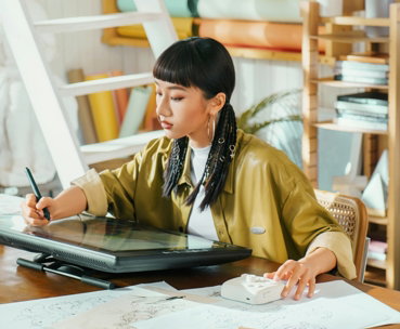 Artist works on a digital tablet in her studio.