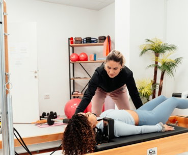 a couple of women are doing exercises in a gym