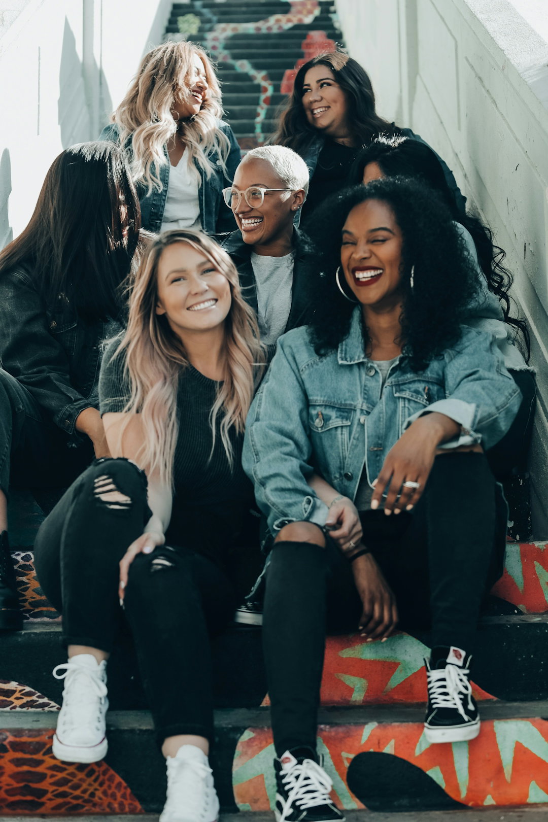 group of women laughing on stairs